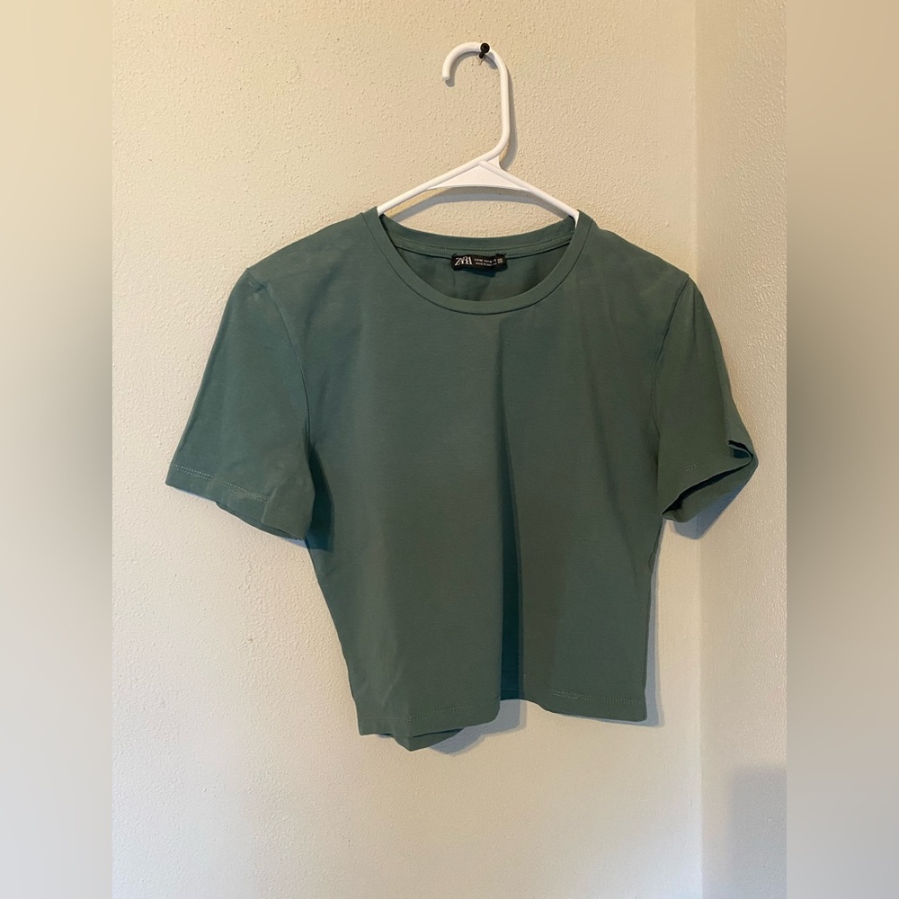 It is a crop women’s top. The brand is Zara.